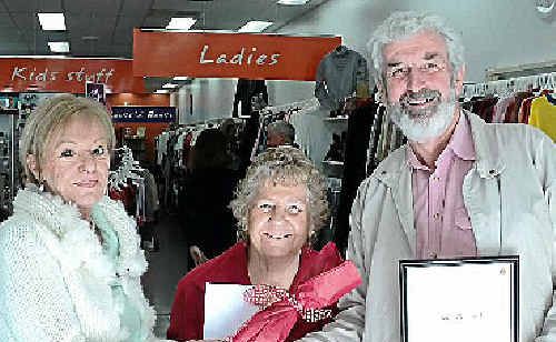 Endeavour area manager Kate Millard and Gympie store manager Peggy Hunter congratulate volunteer John Halwood on winning the service award. Endeavour area manager Kate Millard and Gympie store manager Peggy Hunter congratulate volunteer John Halwood on winning the service award.